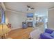 Open-concept living room with hardwood floors, fireplace, and a view into the kitchen and dining area at 303 Crossandra Ave, Summerville, SC 29483