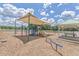 Community playground with slides and swings under a shaded canopy, perfect for children to play at 303 Crossandra Ave, Summerville, SC 29483