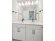Modern bathroom featuring double sink vanity with dark hardware, a large mirror and tile flooring at 3148 Vanessa Lynne Ln, Johns Island, SC 29455