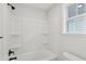 A well-lit bathroom offers a shower-tub combo with black hardware and a window at 3148 Vanessa Lynne Ln, Johns Island, SC 29455