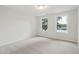 Bright bedroom with neutral walls, carpet, and two windows overlooking a lake at 3148 Vanessa Lynne Ln, Johns Island, SC 29455