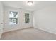 Cozy bedroom with plush carpeting and two windows providing views of a serene lake at 3148 Vanessa Lynne Ln, Johns Island, SC 29455