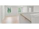 Bright hallway features wood grain floors, staircase, and ample natural light from the two windows at 3148 Vanessa Lynne Ln, Johns Island, SC 29455