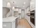 Open concept kitchen with stainless steel appliances and marble countertops next to staircase at 3148 Vanessa Lynne Ln, Johns Island, SC 29455
