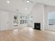 Bright living room with a fireplace, multiple windows, and a glass door at 3148 Vanessa Lynne Ln, Johns Island, SC 29455