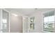 Bright living room with French doors, light wood floors, and windows overlooking the lake at 3148 Vanessa Lynne Ln, Johns Island, SC 29455