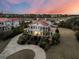 Elegant home with a red roof, set against a backdrop of marshland and vibrant sunset colors at 3232 Pignatelli Cres, Mount Pleasant, SC 29466