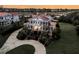 Elegant two-story home with circle drive, black shutters, red roof and landscaped yard at 3232 Pignatelli Cres, Mount Pleasant, SC 29466