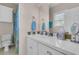 Clean bathroom features a white vanity with tiled countertop, decorative mirror, and patterned shower curtain at 3232 Pignatelli Cres, Mount Pleasant, SC 29466