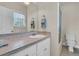 Clean bathroom features a white vanity with tiled countertop, large mirror, and window at 3232 Pignatelli Cres, Mount Pleasant, SC 29466