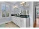 Detailed bathroom features double sinks with a black countertop and framed mirror at 3232 Pignatelli Cres, Mount Pleasant, SC 29466