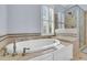 Elegant bathroom featuring a soaking tub, a window with plantation shutters, and a glass enclosed shower at 3232 Pignatelli Cres, Mount Pleasant, SC 29466