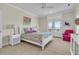 Bright bedroom with a white bed, colorful floral bedding, and French doors leading to a balcony with a view at 3232 Pignatelli Cres, Mount Pleasant, SC 29466