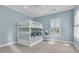 Bright bedroom with a white bunk bed, blue accents, and a window with plantation shutters at 3232 Pignatelli Cres, Mount Pleasant, SC 29466