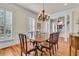 Formal dining room featuring a wood table, chandelier, and wainscoting detail at 3232 Pignatelli Cres, Mount Pleasant, SC 29466