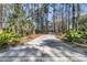 Long private driveway surrounded by a beautifully wooded area with tall trees and lush landscaping at 3232 Pignatelli Cres, Mount Pleasant, SC 29466