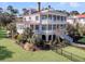 Stunning two-story home with double porches, lush landscaping, and a well-manicured lawn at 3232 Pignatelli Cres, Mount Pleasant, SC 29466