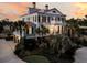 Elegant two-story home with lush landscaping and a charming, well-lit exterior at 3232 Pignatelli Cres, Mount Pleasant, SC 29466