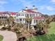 A beautiful two-story home with a professionally landscaped yard and beautiful red roof at 3232 Pignatelli Cres, Mount Pleasant, SC 29466