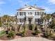 Elegant two-story home with symmetrical design, black shutters, red roof and landscaped yard at 3232 Pignatelli Cres, Mount Pleasant, SC 29466