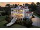 Stunning exterior of a multi-level home featuring wraparound porches and manicured landscaping at 3232 Pignatelli Cres, Mount Pleasant, SC 29466