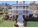Stately two-story home with double porches, elegant white trim, and lush landscaping, offering great curb appeal at 3232 Pignatelli Cres, Mount Pleasant, SC 29466
