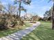 Beautifully landscaped front yard with a winding driveway leading to a classic two-story home at 3232 Pignatelli Cres, Mount Pleasant, SC 29466