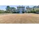 Spacious front yard with a charming two-story home and mature trees at 3232 Pignatelli Cres, Mount Pleasant, SC 29466
