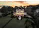 Stately home with a sprawling green lawn and mature trees, all framed by a black metal fence at 3232 Pignatelli Cres, Mount Pleasant, SC 29466