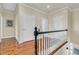 Bright hallway with hardwood floors, fresh paint and white trim offers access to other rooms at 3232 Pignatelli Cres, Mount Pleasant, SC 29466