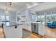 Bright, open kitchen boasts a stainless steel dishwasher, farm sink, and hardwood floors with natural light at 3232 Pignatelli Cres, Mount Pleasant, SC 29466
