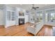 Bright living room featuring a fireplace, built-in shelving, and large French doors at 3232 Pignatelli Cres, Mount Pleasant, SC 29466