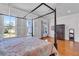 Spacious main bedroom featuring a four-poster bed, hardwood floors, and ample windows at 3232 Pignatelli Cres, Mount Pleasant, SC 29466