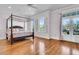 Spacious main bedroom featuring a four-poster bed, light-colored walls, and hardwood floors at 3232 Pignatelli Cres, Mount Pleasant, SC 29466