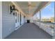 Long exterior porch with blue ceiling and white columns offers outside seating and scenic views at 3232 Pignatelli Cres, Mount Pleasant, SC 29466