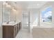 Bathroom featuring a double vanity, tub, and a large window offering natural light at 359 Blue Oak Dr, Moncks Corner, SC 29461