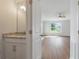A glimpse into a bathroom featuring granite countertop, modern fixtures, and hardwood floors, exuding elegance at 359 Blue Oak Dr, Moncks Corner, SC 29461
