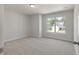 Cozy bedroom with neutral carpeting and natural light from the adjacent window at 359 Blue Oak Dr, Moncks Corner, SC 29461