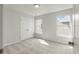 Bright bedroom with neutral carpeting, closet, and natural light from the adjacent window at 359 Blue Oak Dr, Moncks Corner, SC 29461