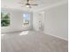 Bright bedroom featuring neutral carpeting and large windows with views of the surrounding greenery at 359 Blue Oak Dr, Moncks Corner, SC 29461