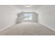 Large bonus room offers neutral colors, plush carpet, and natural light at 359 Blue Oak Dr, Moncks Corner, SC 29461