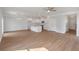 Spacious living area featuring wood floors, white cabinets, a kitchen island, and a view of the backyard at 359 Blue Oak Dr, Moncks Corner, SC 29461