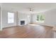 Bright living room with a fireplace, wood floors, large windows, and natural light at 359 Blue Oak Dr, Moncks Corner, SC 29461