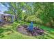 Large backyard with patio, gazebo, fire pit, landscaping, and mature trees at 380 Furman Ln, Ladson, SC 29456