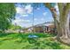 Expansive backyard with lush green grass, mature trees, patio with gazebo, and swing at 380 Furman Ln, Ladson, SC 29456