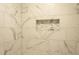 Shower with stylish marble-look tile and a built-in niche for storage at 380 Furman Ln, Ladson, SC 29456
