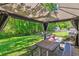 Charming gazebo with dining table and seating with views of large backyard at 380 Furman Ln, Ladson, SC 29456