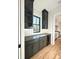 Chic bar area featuring dark cabinets, a wine cooler, and elegant backsplash at 3845 Delinger Dr, Mount Pleasant, SC 29466