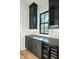 Stylish bar area with dark cabinetry, mosaic backsplash, and a wine cooler at 3845 Delinger Dr, Mount Pleasant, SC 29466