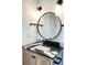 Bathroom vanity with a black and white countertop, modern faucet, round mirror and wall-mounted towel bars at 3845 Delinger Dr, Mount Pleasant, SC 29466